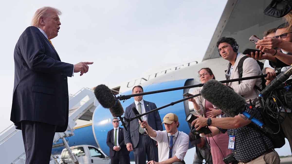 resident Donald Trump talks to reporters before he boards Air Force One at Palm Beach International Airport in West Palm Beach, Fla. | AP