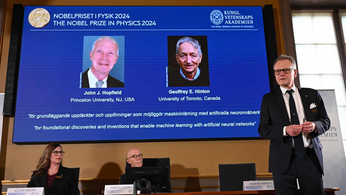 A screen shows the laureates of the 2024 Nobel Prize in Physics, US physicist John J. Hopfield and Canadian-British computer scientist and cognitive psychologist Geoffrey E Hinton | AFP