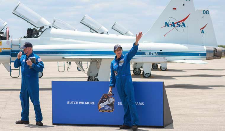 NASAs Boeing Crew Flight Test Commander Butch Wilmore (L) and Pilot Suni Williams address the media after arriving at the Kennedy Space Center in a T-38 jet on April 25, 2024 in Cape Canaveral, Florida | AFP