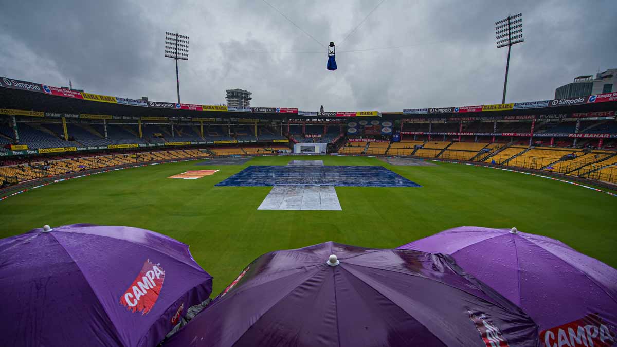 The pitch covered during rains on the first day of the first Test match between India and New Zealand at M. Chinnaswamy Stadium, in Bengaluru | PTI
