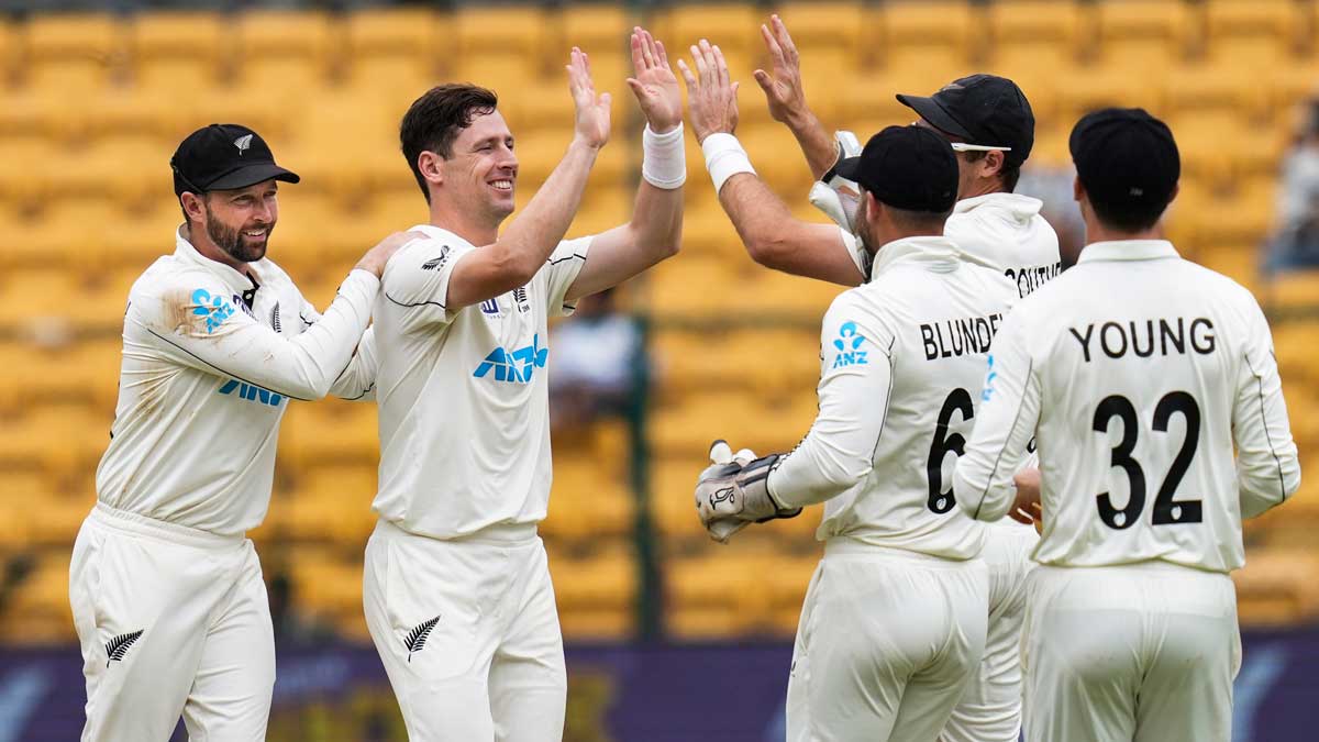 New Zealand's Matt Henry celebrates with teammates after taking the wicket of India's R. Ashwin on the second day of the first Test match, in Bengaluru | PTI