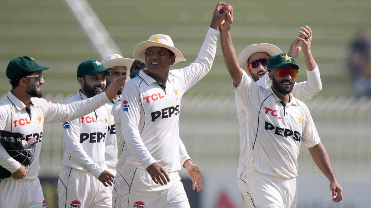 Pakistan's Noman Ali, centre, and Sajid Khan, right, display the ball jointly as they walk off the field at the end of England's second innings in the third Test, in Rawalpindi | AP