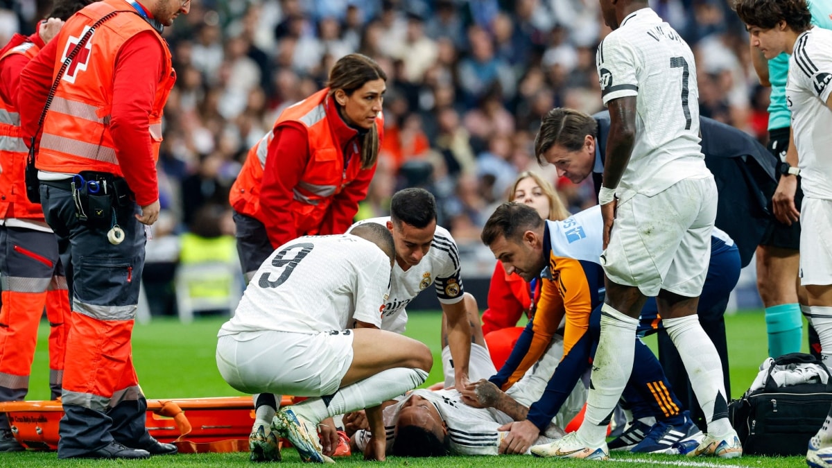 Teammates check on Real Madrid's defender Eder Militao as he is put on a stretcher after sustaining an injury | AFP