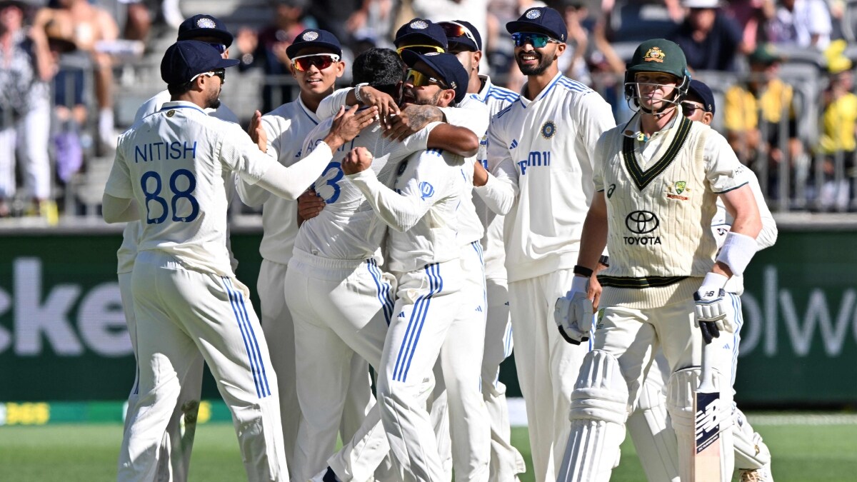 India's Viral Kohli hugs paceman Jasprit Bumrah for his wicket of Australias Steve Smith | AFP