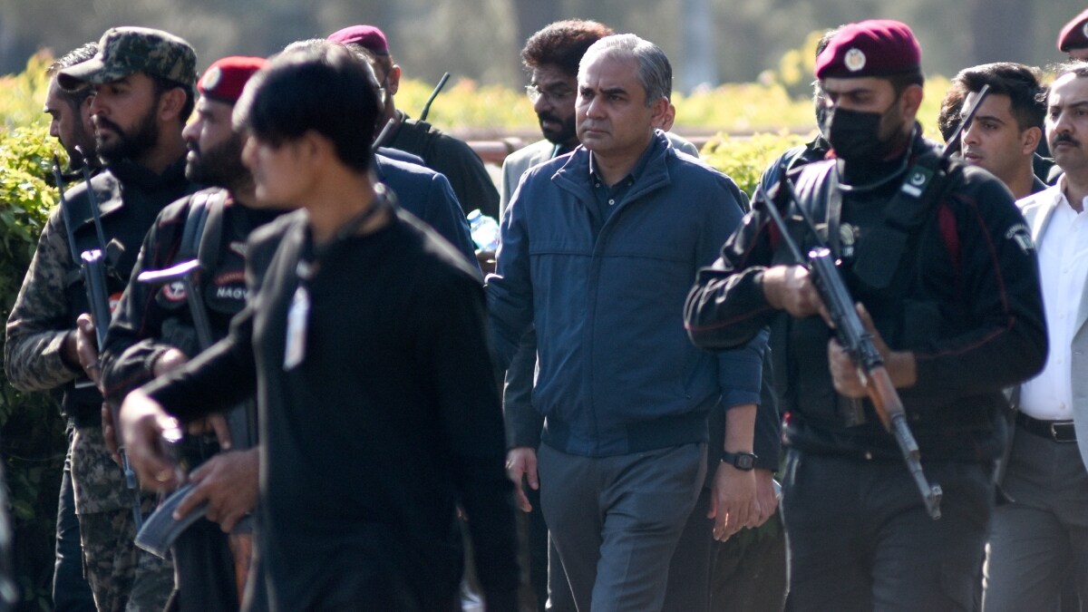 Security officials escort Pakistan's Interior Minister Mohsin Naqvi | AP