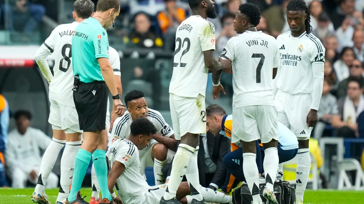Real Madrid's Rodrygo sits on the pitch after an injury during the Spanish La Liga match against Osasuna at the Santiago Bernabeu. Eder Militao, who was injured later, can also be seen | AP 