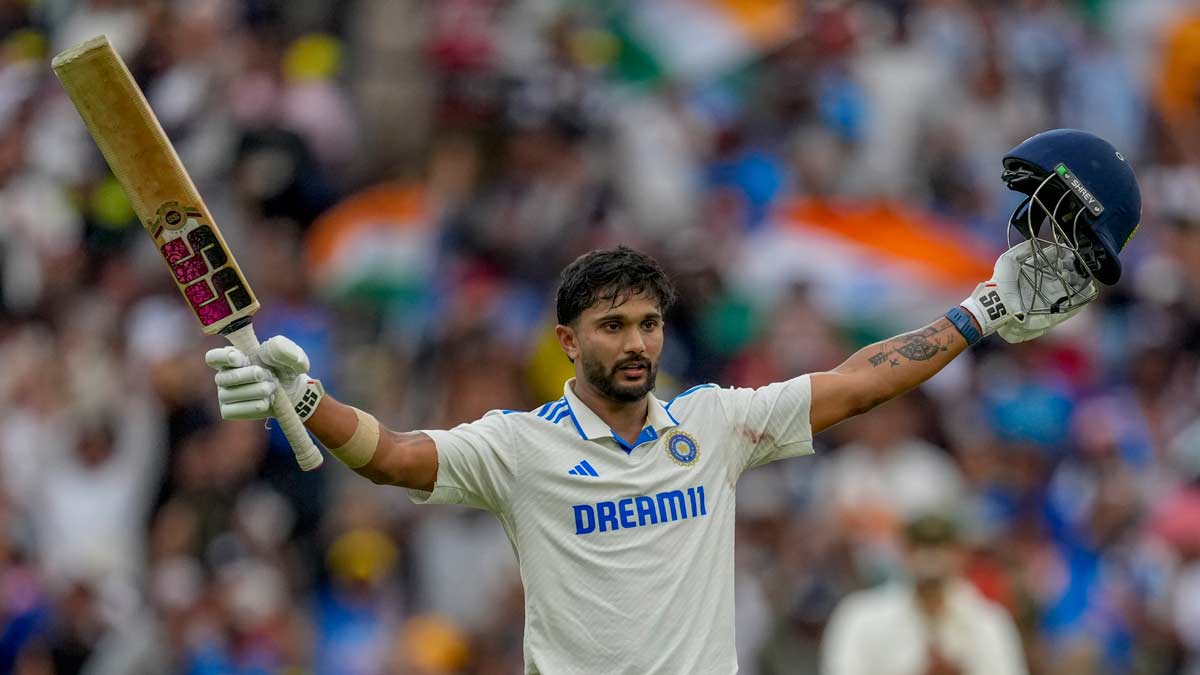 Nitish Kumar Reddy raises his bat as he celebrates after scoring his century during play on the third day of the fourth Test between Australia and India at the Melbourne Cricket Ground | AP