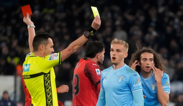 Referee Marco di Bello shows the red card to Lazio's Matteo Guendouzi and the yellow card to AC Milan's Christian Pulisic | AP