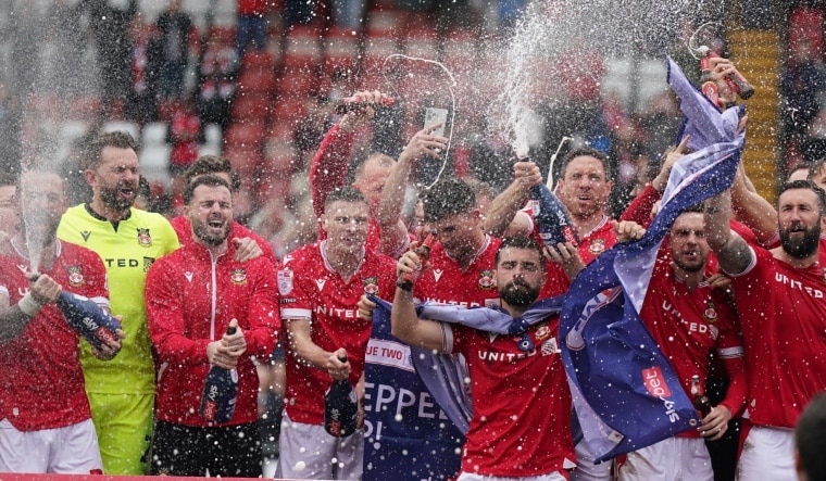 Wrexham players on the pitch celebrate promotion to League One | AP