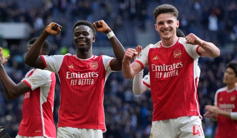 Arsenal's Bukayo Saka and Declan Rice celebrate at the end of their English Premier League match against Tottenham Hotspur | AP