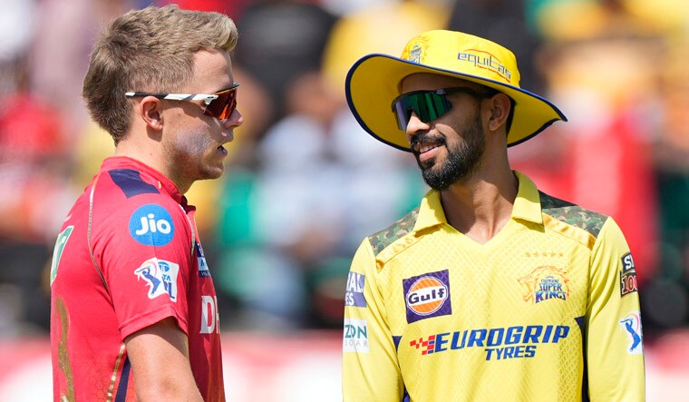 Chennai Super Kings' captain Ruturaj Gaikwad, right, and Punjab Kings' captain Sam Curran chat before the coin toss of the Indian Premier League cricket match between Chennai Super Kings and Punjab Kings in Dharamshala, India, Sunday, May 5, 2024. (AP Photo /Ashwini Bhatia)