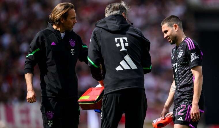 Bayern Munich's Raphael Guerreiro leaves the pitch injured | AP