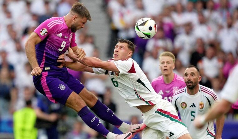 Germany's Niclas Fuellkrug (L) heads the ball as Hungary's Willi Orban defends during a Group A match at the Euro 2024 | AP