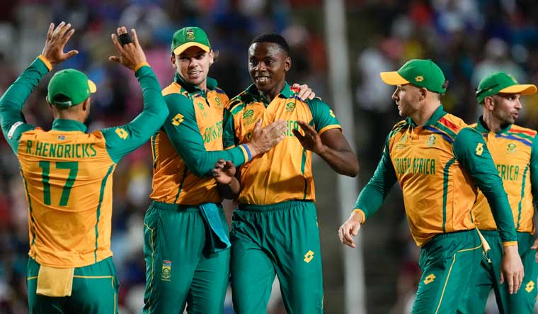 South Africa's Kagiso Rabada, centre, is congratulated by teammates after dismissing Afghanistan's Mohammad Nabi during the men's T20 World Cup semifinal cricket match between Afghanistan and South Africa at the Brian Lara Cricket Academy in Tarouba, Trinidad and Tabago | AFP