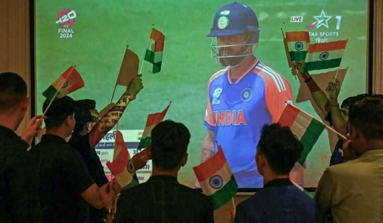 Fans watch Indian cricketer Virat Kohli on a screen during a live telecast of the ICC men's Twenty20 World Cup 2024 final | AFP
