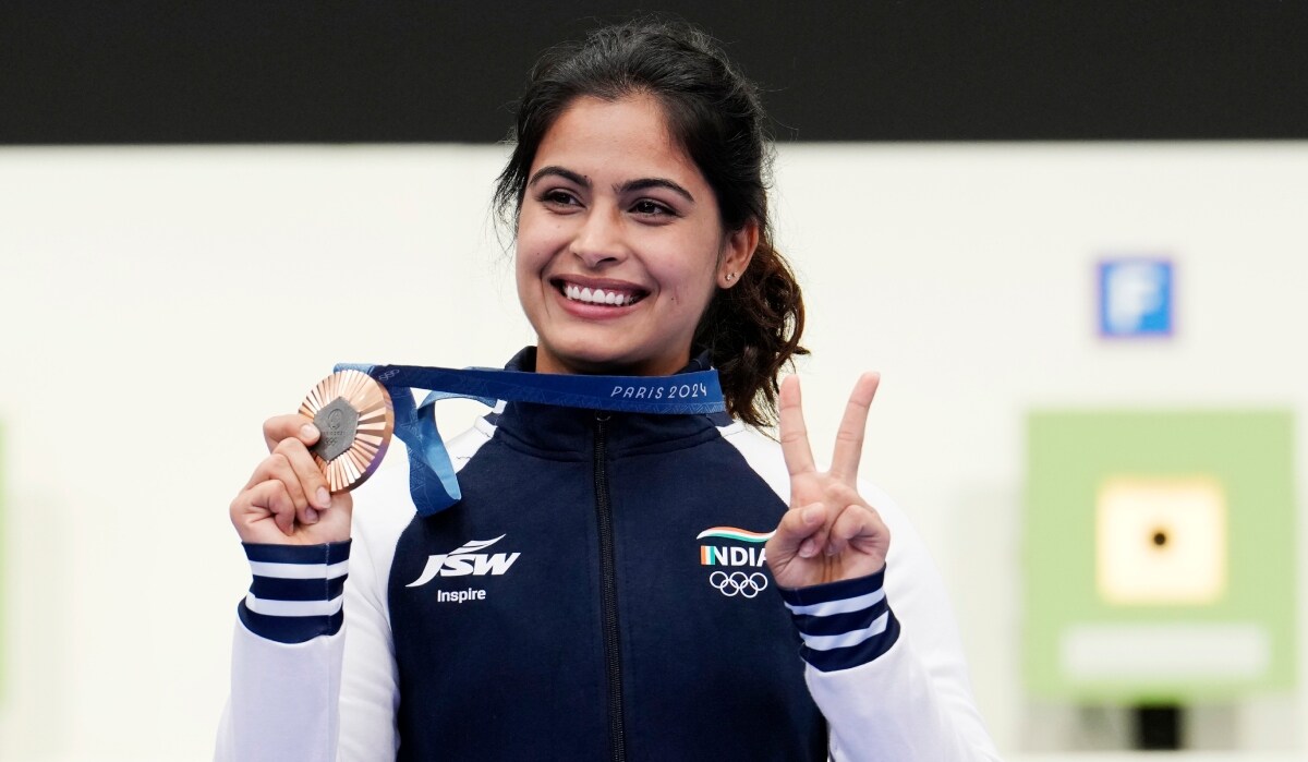 India's Manu Bhaker poses for a photograph with her bronze medal after finish third in the 10m air pistol women's final round at the 2024 Paris  Summer Olympics | AP