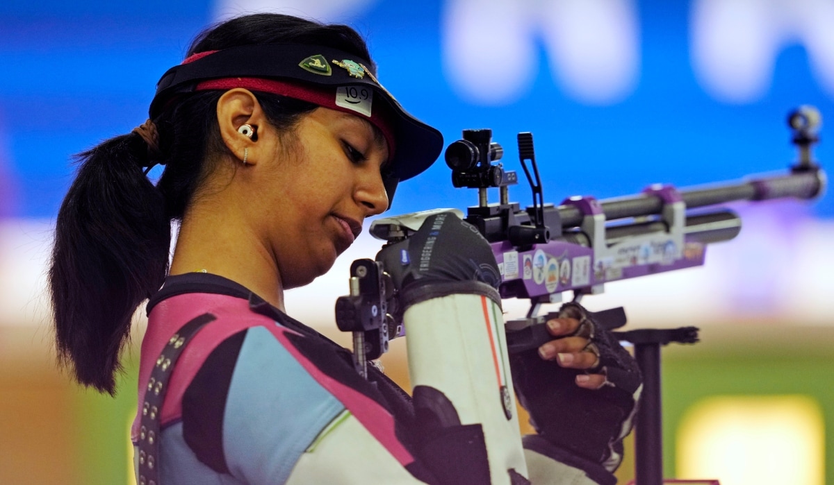 India's Ramita Jindal looks at her rifle as he competes in the 10m air rifle mixed team qualification round at the 2024 Paris Summer Olympics | AP