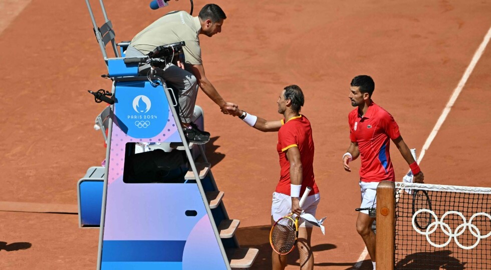 Spain's Rafael Nadal shakes hands with chair umpire Renaud Lichtenstein of France after his defeat to Serbia's Novak Djokovic (R) | AFP