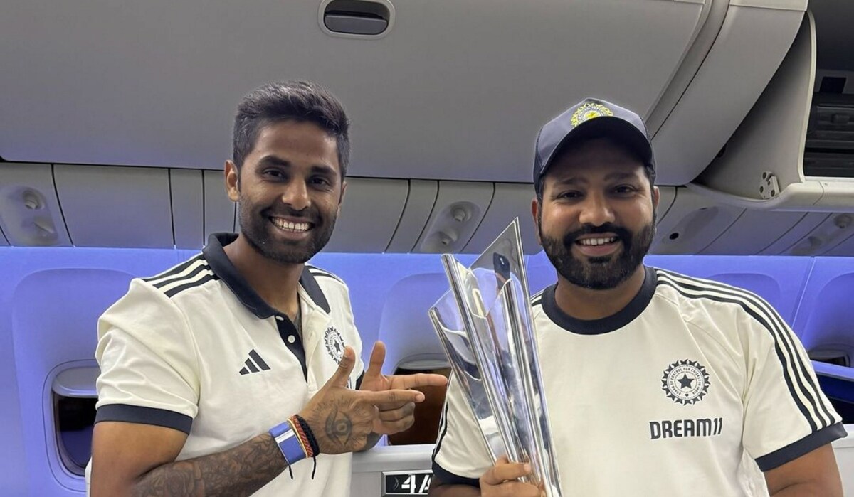 India's captain Rohit Sharma with Suryakumar Yadav pose with the ICC Mens T20 cricket World Cup 2024 trophy aboard a flight as they depart for India | PTI