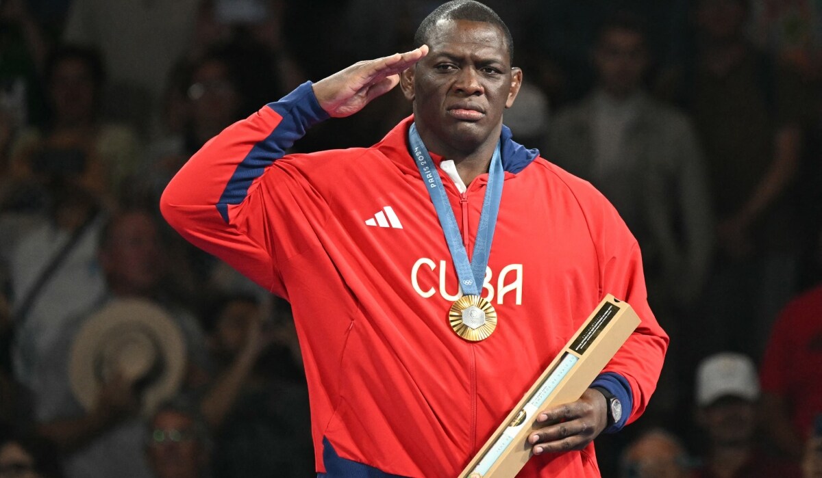 Paris Games gold medallist Cuba's Mijain Lopez Nunez poses with his medal at the presentation ceremony for the men's greco-roman 130kg wrestling event | AFP