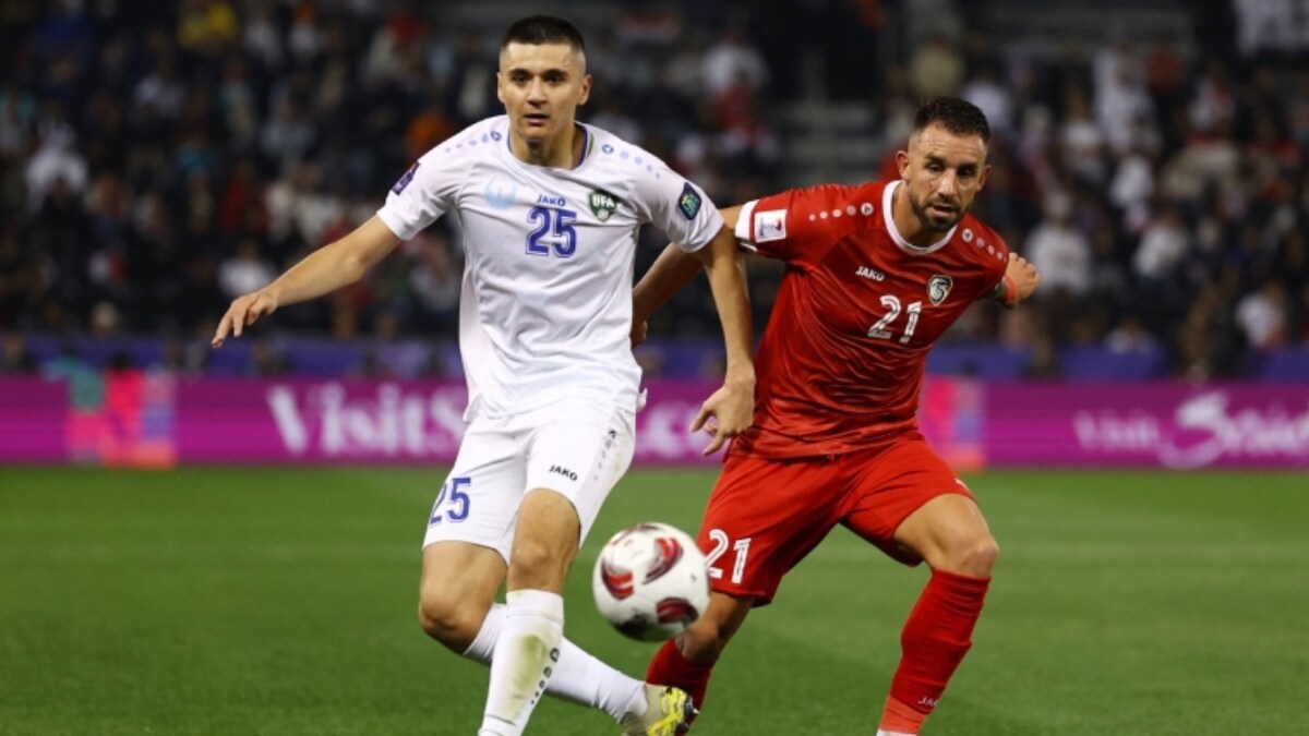 Abdukodir Khusanov (L) in action for his national team | Reuters