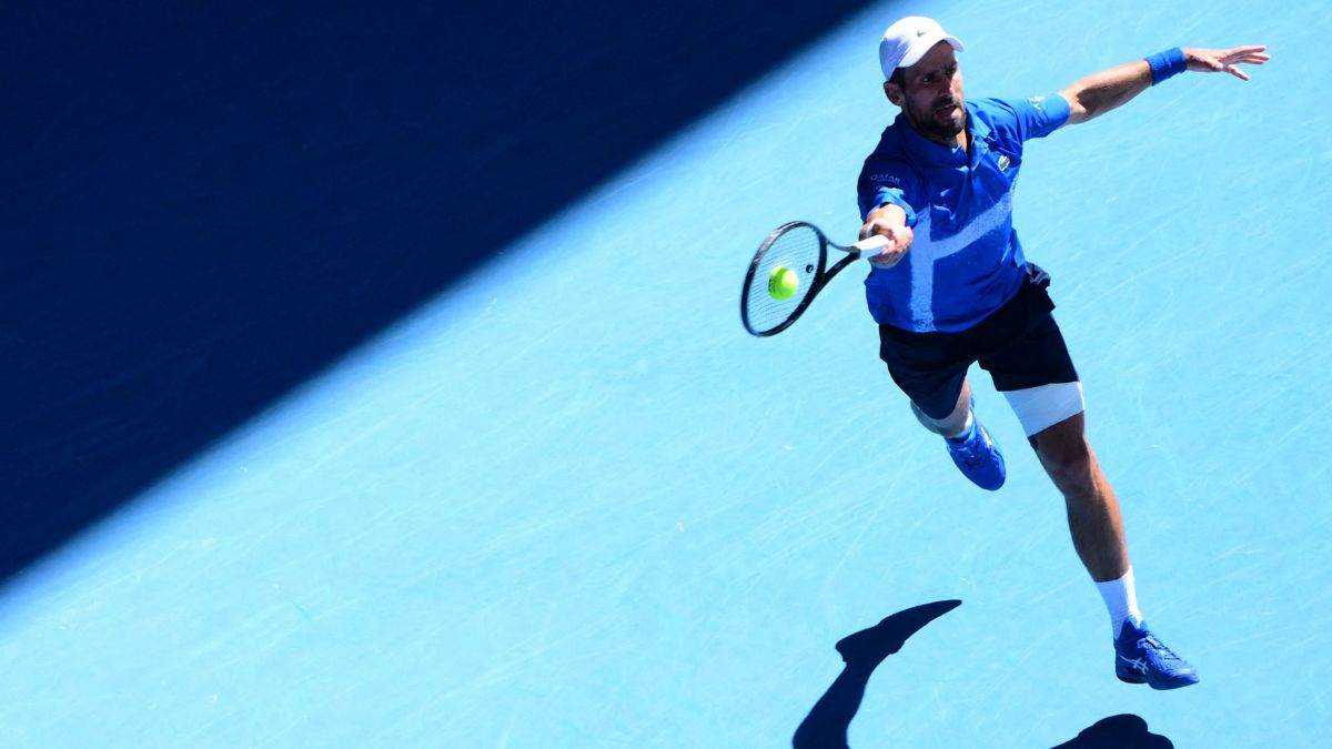 Novak Djokovic hits a return against Alexander Zverev during their men's singles semifinal match | AFP