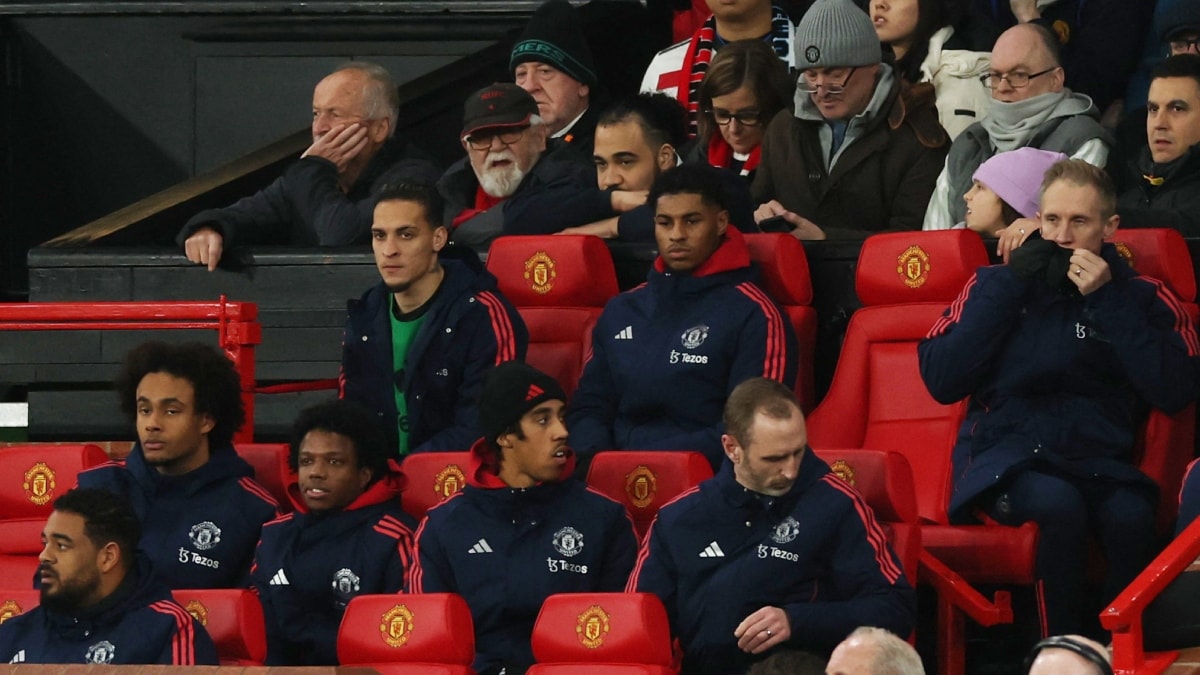 Manchester United's Antony and Marcus Rashford sit on the substitutes bench with other teammates | Reuters
