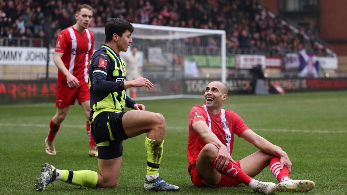 Manchester City's Abdukodir Khusanov (L) and Leyton Orient's Darren Pratley during the FA Cup clash | Reuters