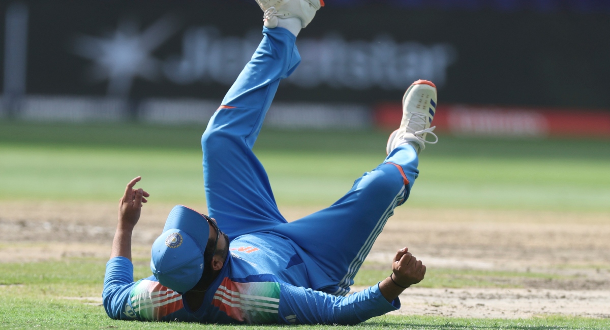 Indian captain Rohit Sharma falls after failing to take the catch of New Zealand's Daryl Mitchell | AP