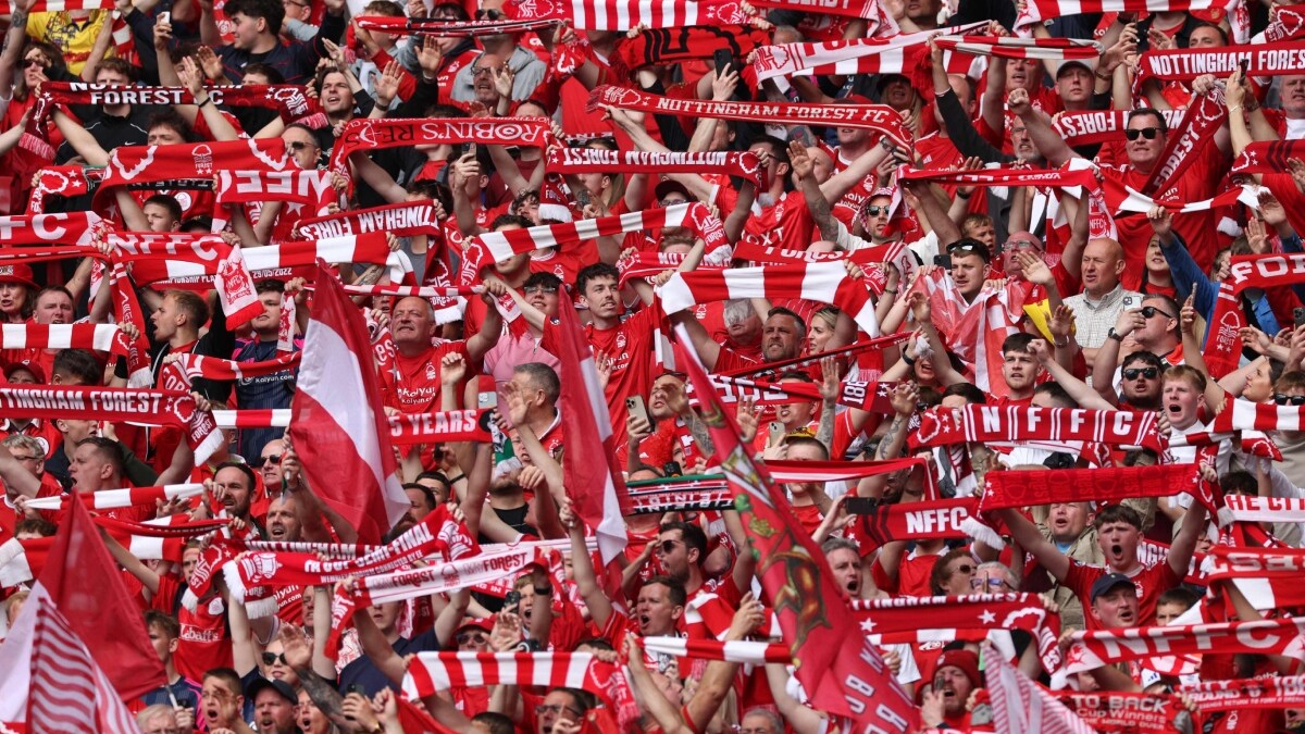 Nottingham Forest fans cheers and wave scarves ahead of a game | AFP