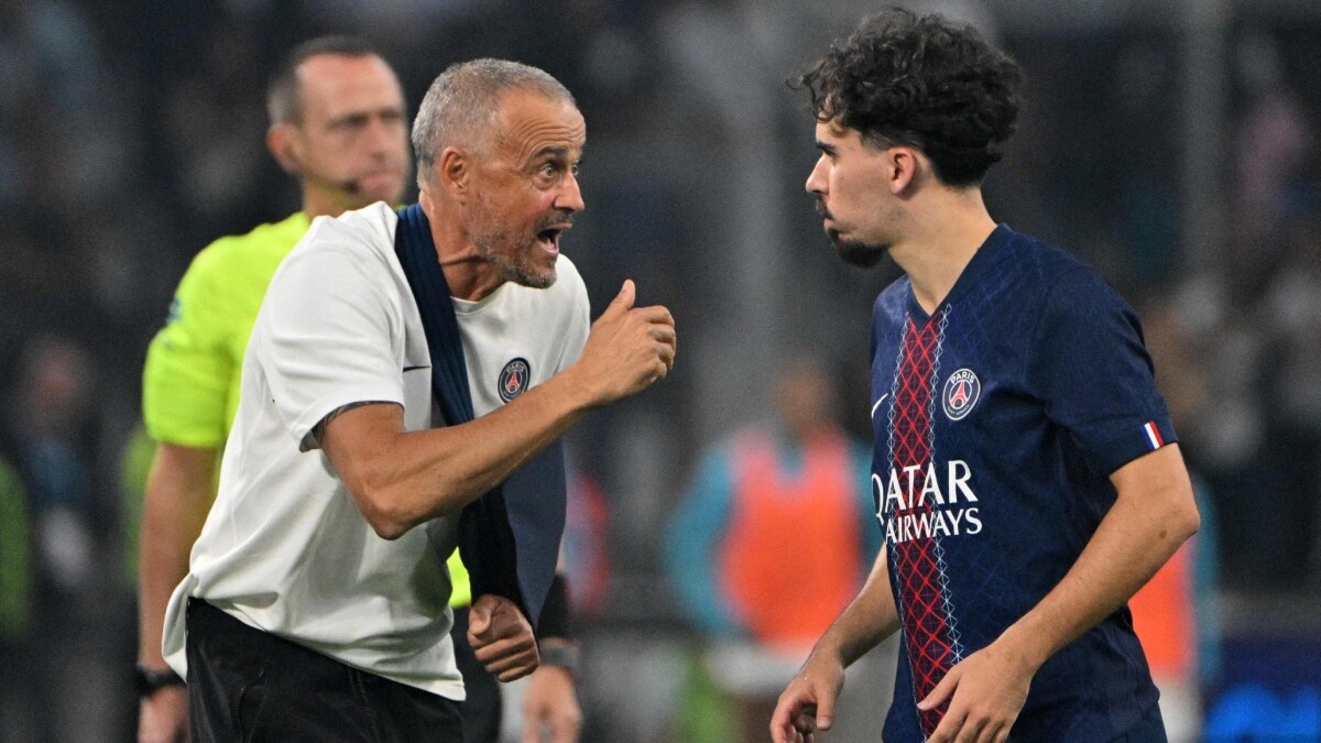 Paris Saint-Germain's Spanish headcoach Luis Enrique gives instruction to midfielder Vitinha | AFP
