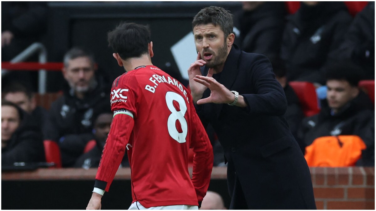 Manchester United's interim head coach Michael Carrick speaks with his captain Bruno Fernandes | AFP