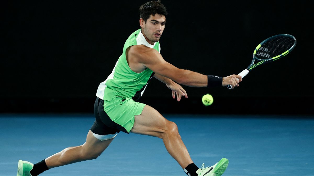 Spain's Carlos Alcaraz hits a return to Serbia's Novak Djokovic during their men's singles final match on day fifteen of the Australian Open tennis tournament in Melbourne | AFP 