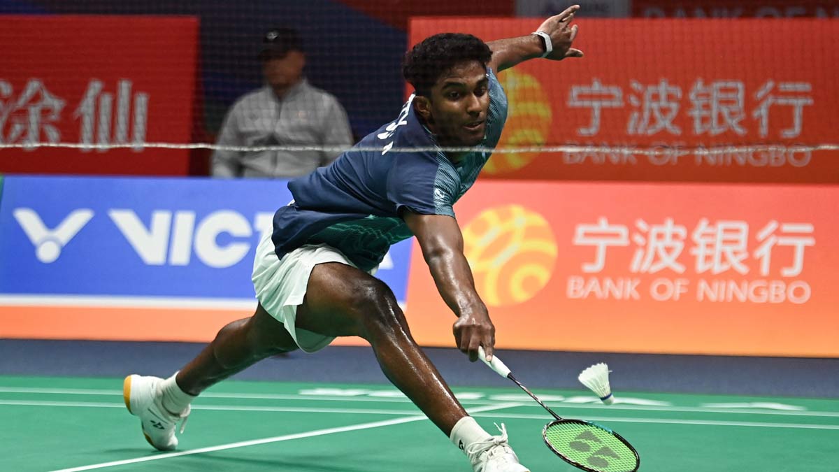 Ayush Shetty hits a return to Thailand's Kunlavut Vitidsarn during their men's singles semifinal match at the Badminton Asia Championship in Ningbo, eastern China's Zhejiang province | AFP