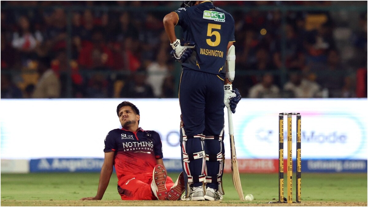 RCB's Rasikh Salam Dar reacts to an injury | Reuters