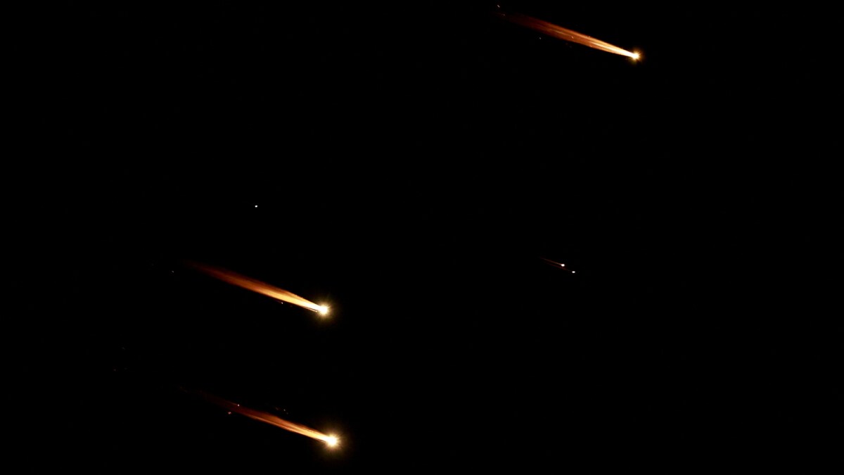 Rockets fly in the sky after Iran fired a salvo of ballistic missiles at Israel | Reuters