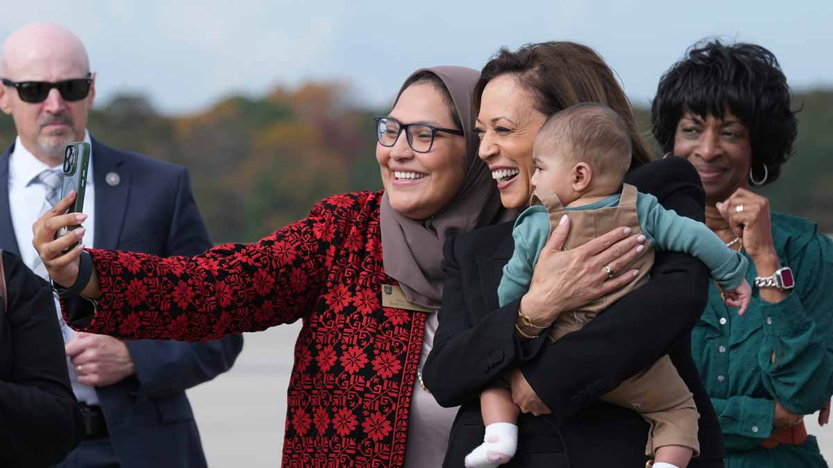 Kamala Harris poses for a photo with Chairwoman Nida Allam, Durham County Board of Commissioners and her son Abdul Allam Aziz as she arrives at RaleighDurham International Airport in Morrisville | AP
