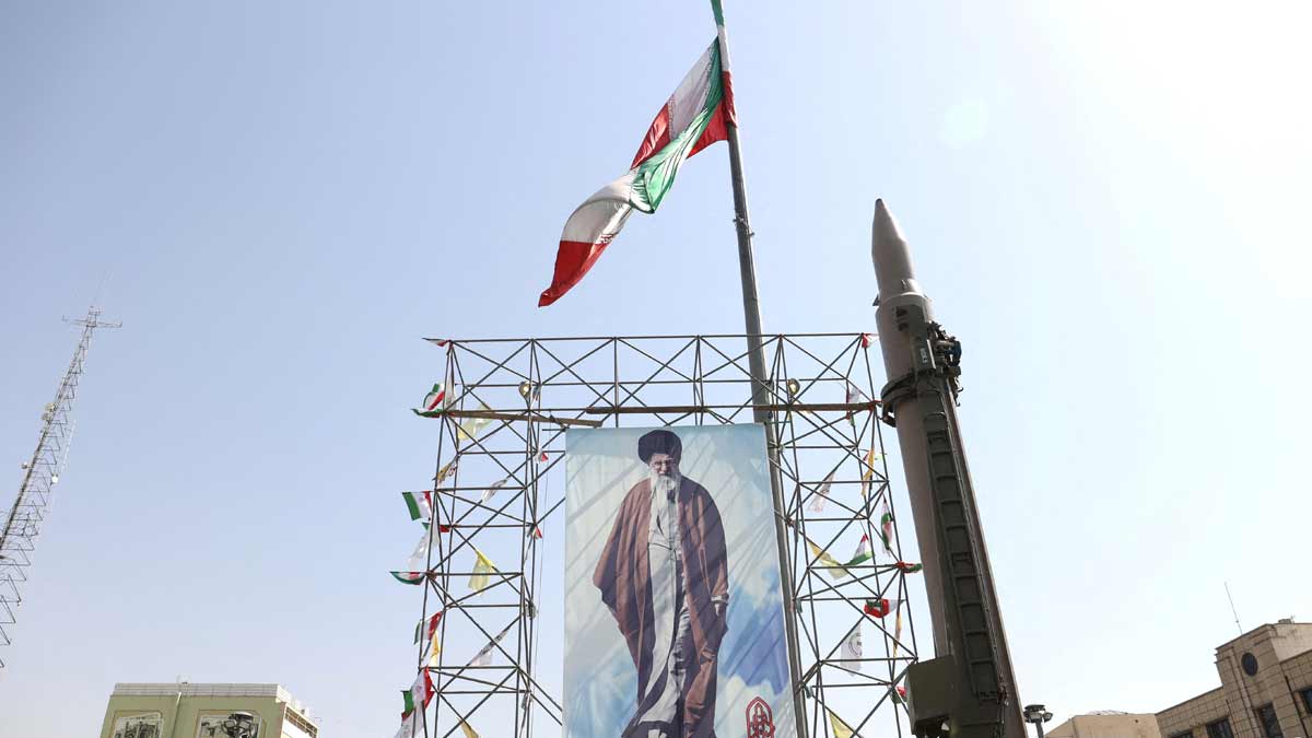 : An Iranian missile system is displayed next to a banner with a picture of Iran's Supreme Leader Ayatollah Ali Khamenei and the late Lebanon's Hezbollah leader Hassan Nasrallah, in a street in Tehran | Reuters