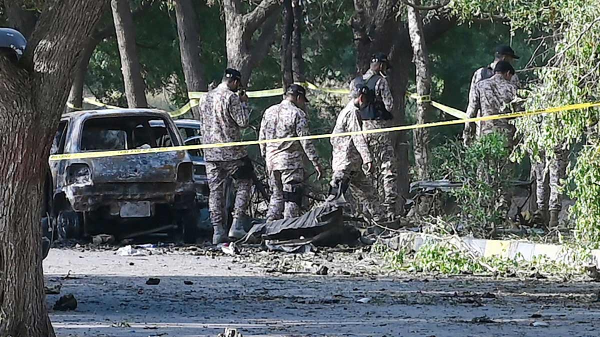 Security personnel inspect the site, a day after an explosion allegedly by separatist militants targeted a high-level convoy of Chinese engineers and investors near the Karachi international airport in Karachi | AFP