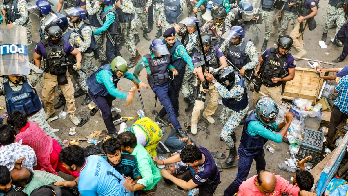 Police personnel baton-charge protesting supporters of Chinmoy Krishna Das Brahmachari  during a demonstration after court denied his bail in Chittagong on November 26 | AFP