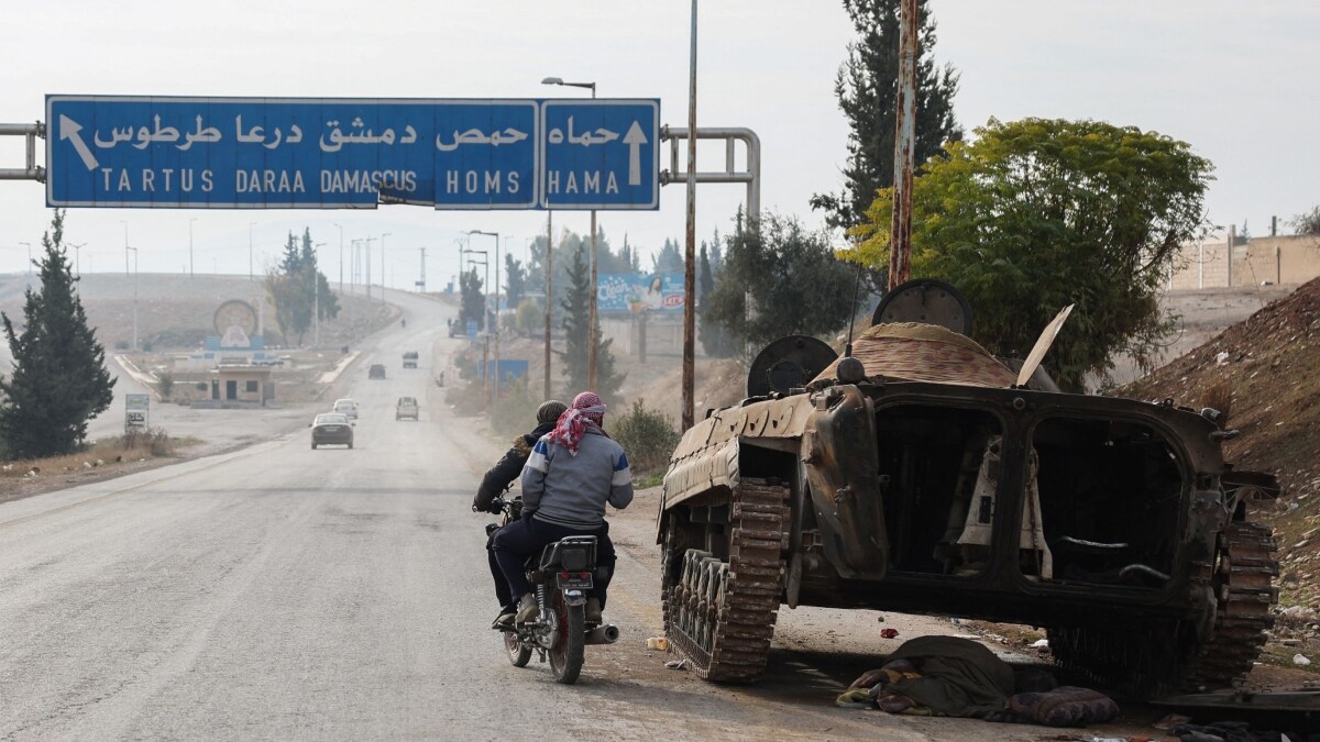 A military vehicle belonging to the Syrian regime forces is pictured abandoned on the side of a road in the Hama governorate | AFP