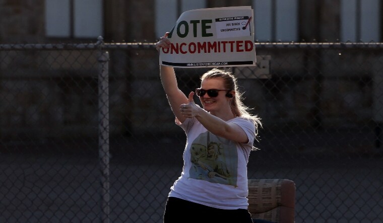 Democratic voter uncommitted to President Joe Biden rallies outside a polling location | AFP