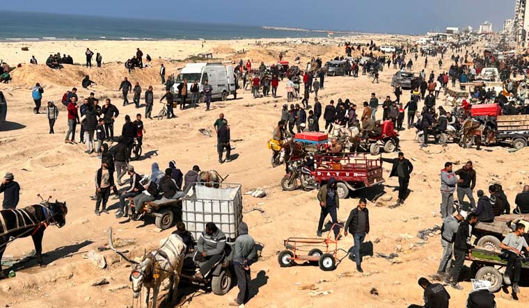 Palestinians wait for humanitarian aid on a beachfront in Gaza City, Gaza Strip, Sunday, Feb. 25, 2024 | AP

