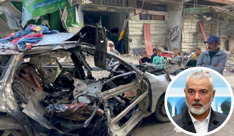 Onlookers check the car in which three sons of Hamas leader Ismail Haniyeh (inset) were reportedly killed in an Israeli air strike in al-Shati camp, west of Gaza City on April 10, 2024 | AFP/AP