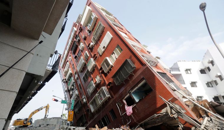 Debris surrounds a titled building a day after a powerful earthquake struck, in Hualien City, eastern Taiwan, on April 4, 2024 | AP