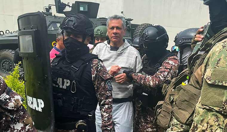 This handout picture released by the Ecuadorian Police shows former Ecuadorian vice president Jorge Glas being escorted by police during his arrival at the maximum security prison La Roca | AFP