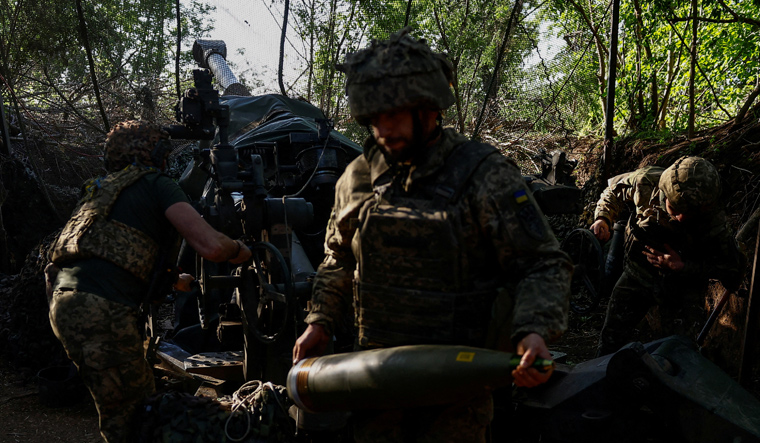 Ukrainian servicemen of the 148th Separate Artillery Brigade of the Ukrainian Air Assault Forces, fire a M777 howitzer toward Russian troops near a front line, amid Russia’s attack on Ukraine, in Donetsk region, Ukraine | Reuters