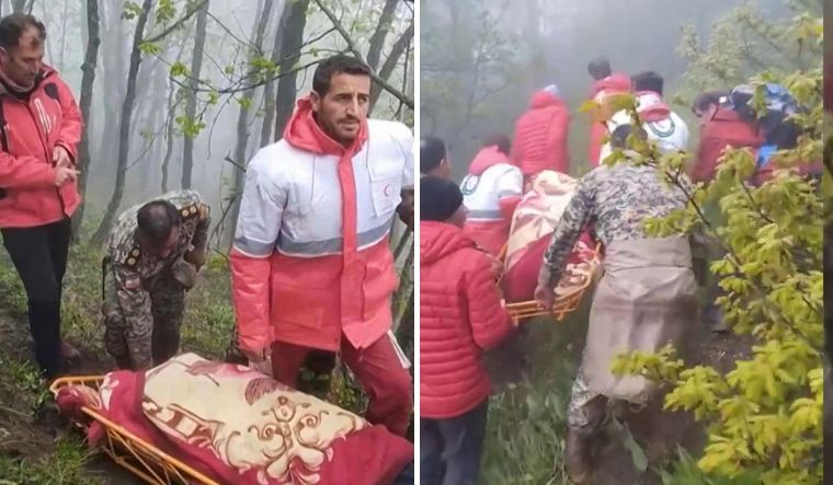 This grab taken from handout video footage released by the Iranian Red Cescent  shows rescuers recovering bodies at the site of President Ebrahim Raisi's helicopter crash in a fog-shrouded mountainous area of northwest Iran | ANI