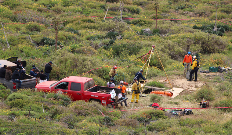 Members of a rescue team work at a site where three bodies were found in the state of Baja California where one American and two Australian tourists were reported missing, in La Bocana | Reuters