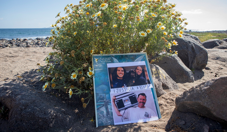 The photos of the foreign surfers who disappeared are placed on the beach in Ensenada, Mexico | AP